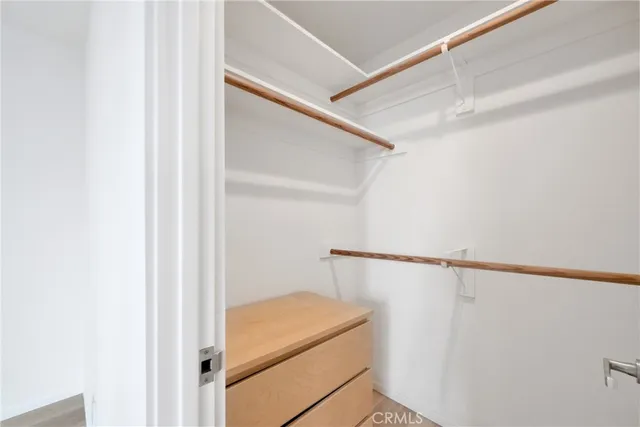 a view of an empty room with window and stairs