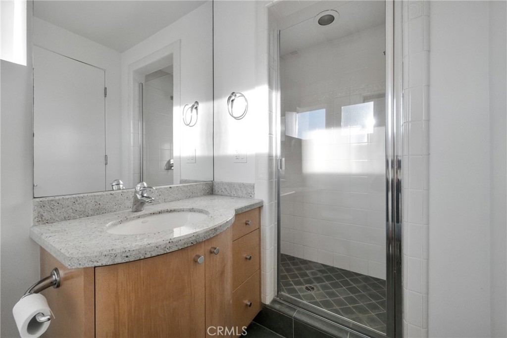 514 Ardmore Avenue Hermosa Beach, CA 90254 - Photo 37 of 54 a bathroom with a granite countertop sink and a mirror
