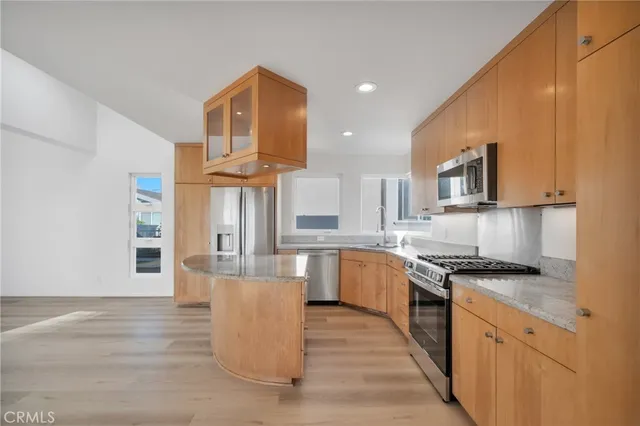 a view of kitchen and hall with wooden floor