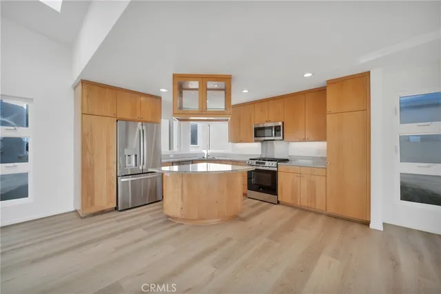 a kitchen with stainless steel appliances granite countertop a stove a sink and a refrigerator