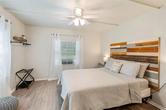 a bedroom with a bed dresser and a window