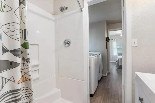 a bathroom with a bathtub and shower