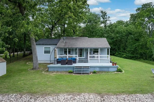 a front view of a house with a yard table and chairs