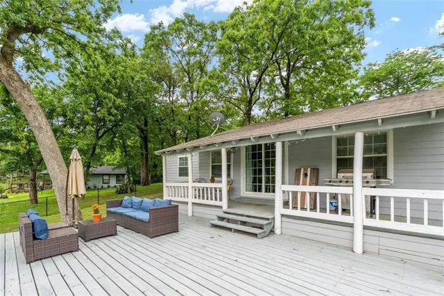 a view of a deck with couches floor to ceiling window and wooden floor