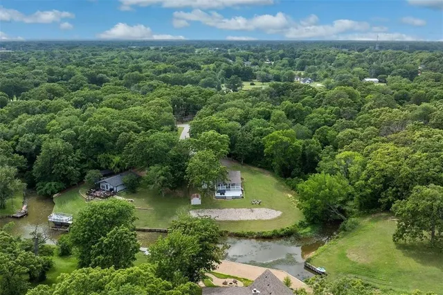 an aerial view of a house with a yard