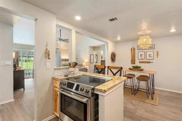 a view of a kitchen counter space a sink and appliances