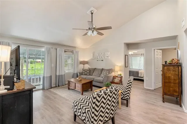a living room with furniture a fireplace and a chandelier