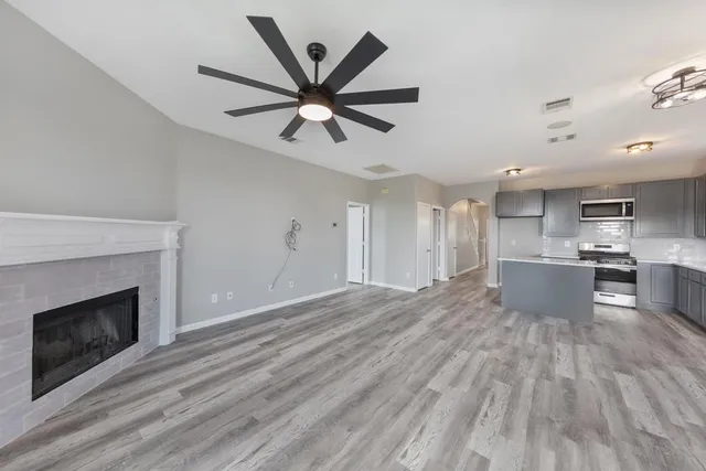 a view of a kitchen with a sink and a fireplace