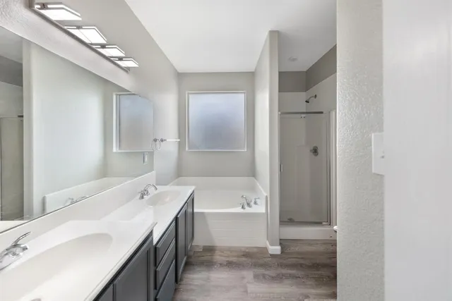 a bathroom with a tub sink and mirror