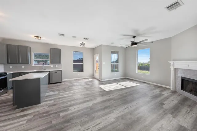 a large kitchen with kitchen island a sink stainless steel appliances and cabinets
