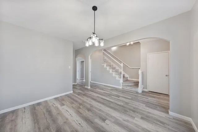 a view of a room with wooden floor and staircase
