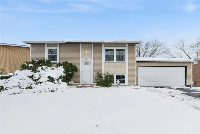 front view of a house with a covered with snow in front of house
