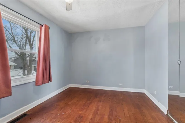 a view of a room with wooden floor and windows