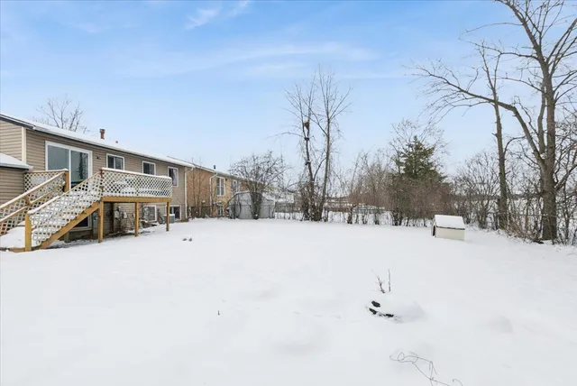 a view of a house with a snow in the yard