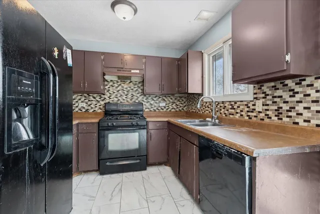 a kitchen with granite countertop a stove and cabinets