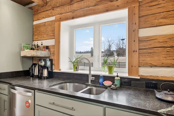 a view of a refrigerator in kitchen and wooden floor