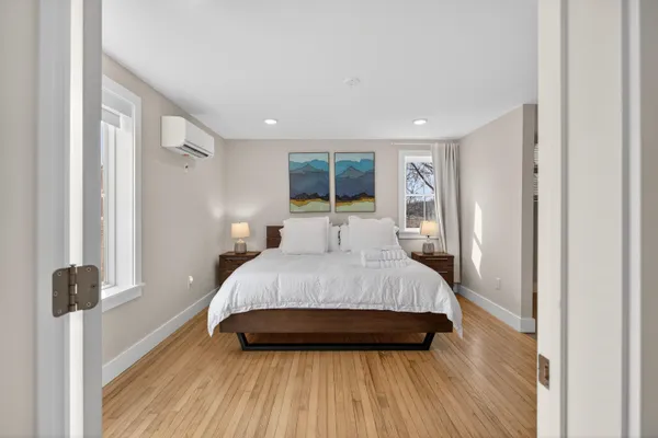 a bedroom with a bed and a window