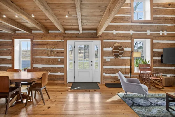 a dining room with furniture and wooden floor