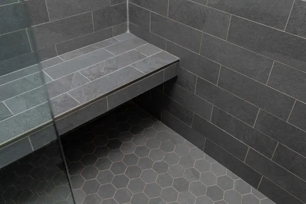 a bathroom with a granite countertop double vanity sink and a mirror