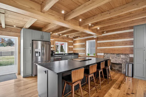 a kitchen with a table and chairs in it