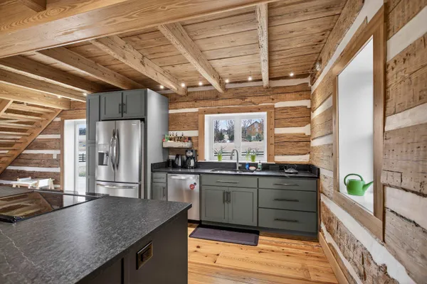 a kitchen with a stove top oven and cabinets