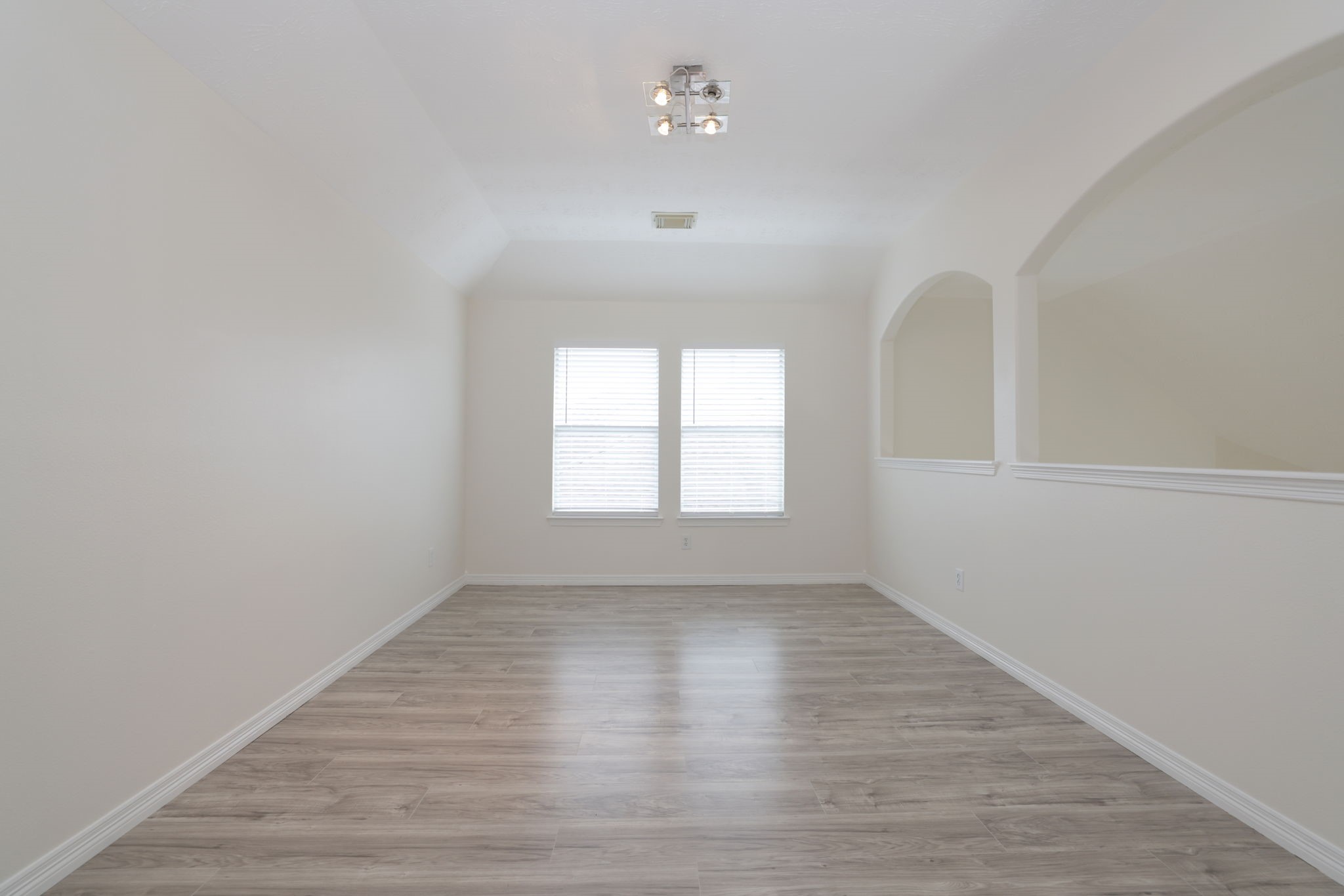 3031 Country Boy Court Spring, TX 77373 - Photo 22 of 35 an empty room with wooden floor and windows