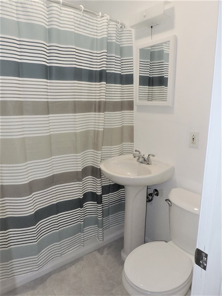 4219 Ostrander Road Rockford, IL 61107 - Photo 11 of 16 a bathroom with a sink a toilet and shower