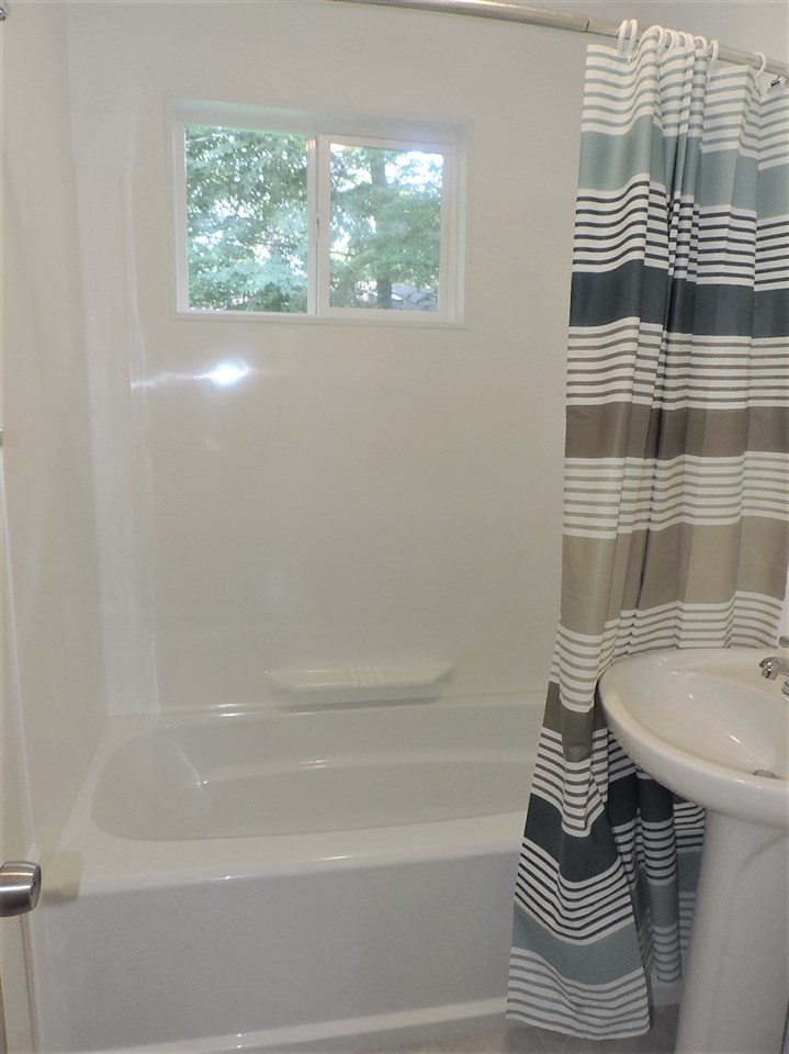4219 Ostrander Road Rockford, IL 61107 - Photo 12 of 16 a bathroom with a sink and a bathtub