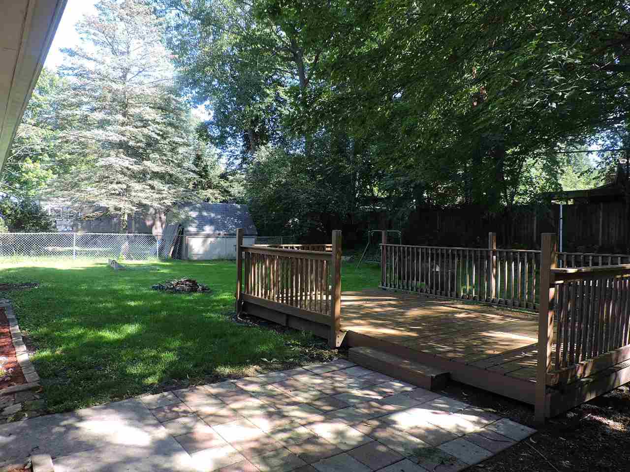 4219 Ostrander Road Rockford, IL 61107 - Photo 15 of 16 a view of a wooden deck with a bench