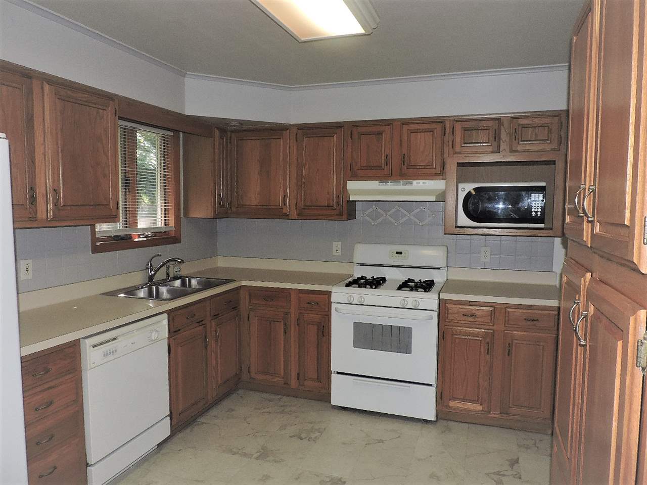 4219 Ostrander Road Rockford, IL 61107 - Photo 3 of 16 a kitchen with a stove sink and cabinets