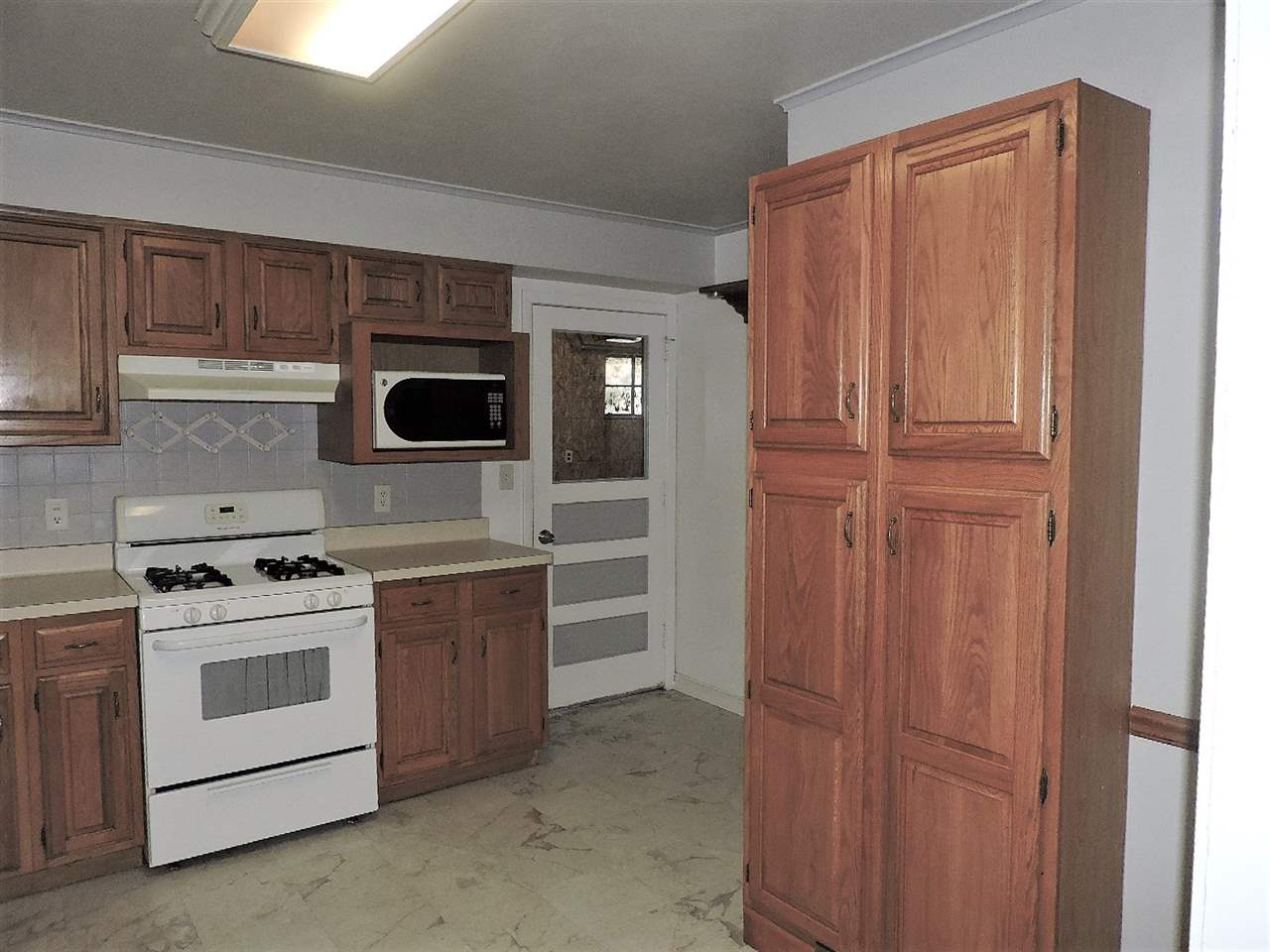 4219 Ostrander Road Rockford, IL 61107 - Photo 5 of 16 a kitchen with stainless steel appliances granite countertop a stove and a refrigerator