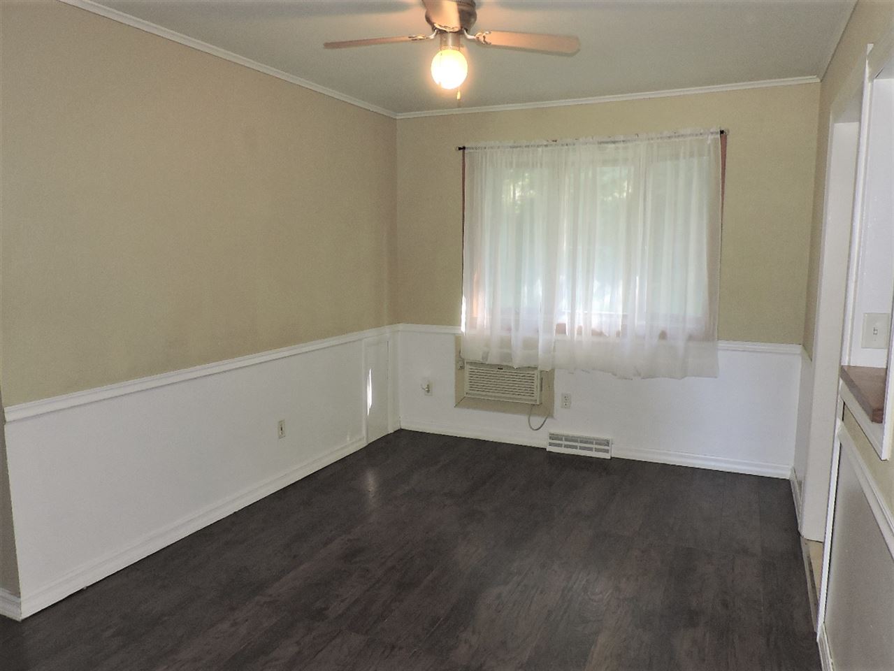 4219 Ostrander Road Rockford, IL 61107 - Photo 6 of 16 an empty room with wooden floor and windows
