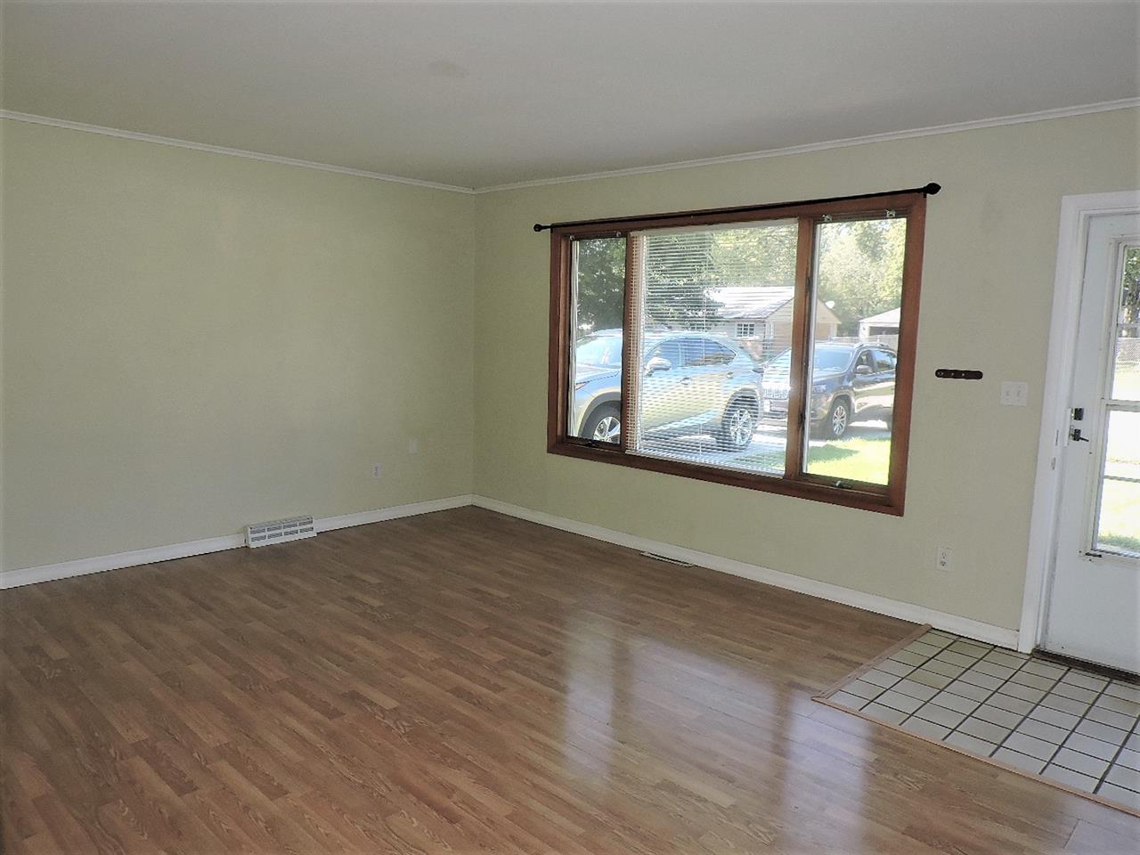4219 Ostrander Road Rockford, IL 61107 - Photo 7 of 16 an empty room with wooden floor and windows