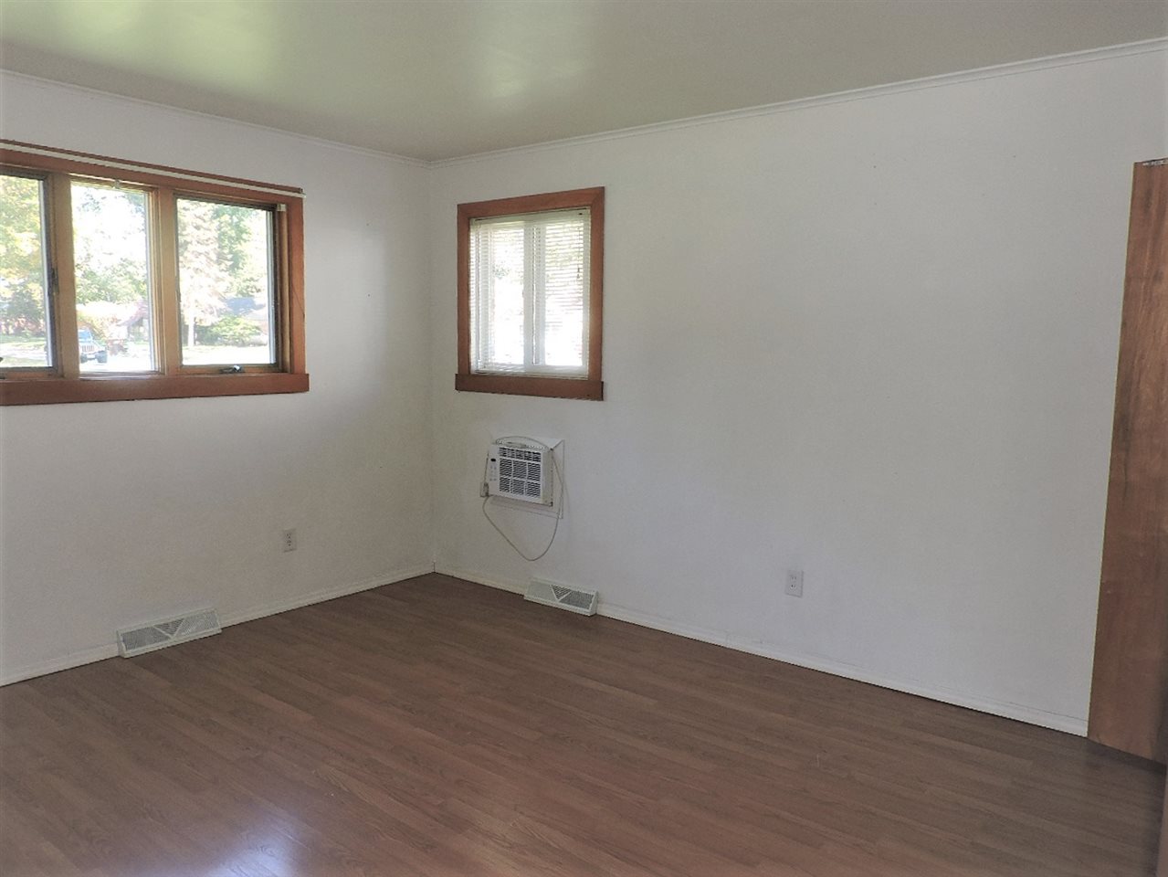 4219 Ostrander Road Rockford, IL 61107 - Photo 8 of 16 a view of an empty room with wooden floor and a window