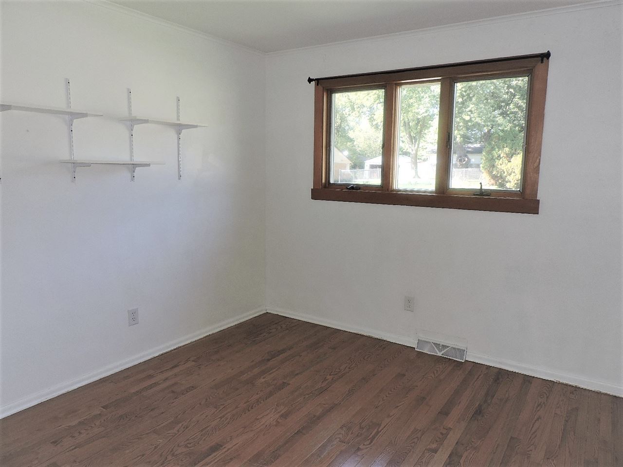 4219 Ostrander Road Rockford, IL 61107 - Photo 9 of 16 wooden floor in an empty room with a window