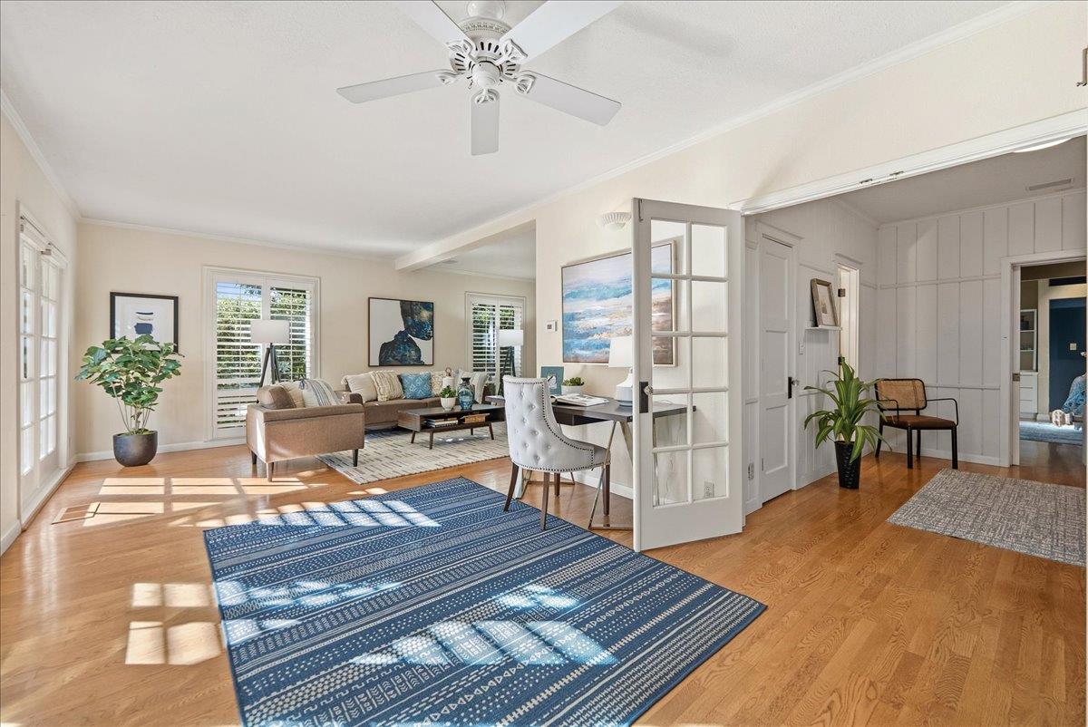 a living room with furniture a table and wooden floor