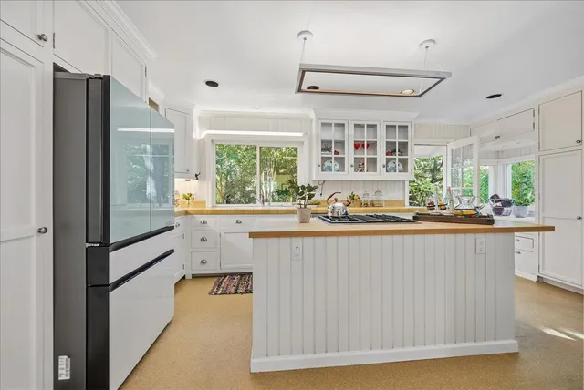 a kitchen with stainless steel appliances granite countertop a stove and a refrigerator