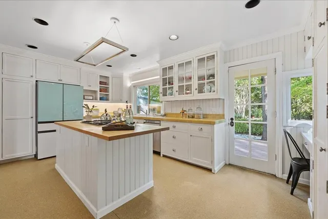 a kitchen with a stove a refrigerator and a oven