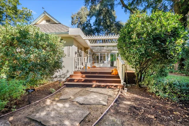 a front view of a house with a garden