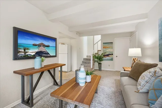 a kitchen that has a lot of furniture in it and wooden floors