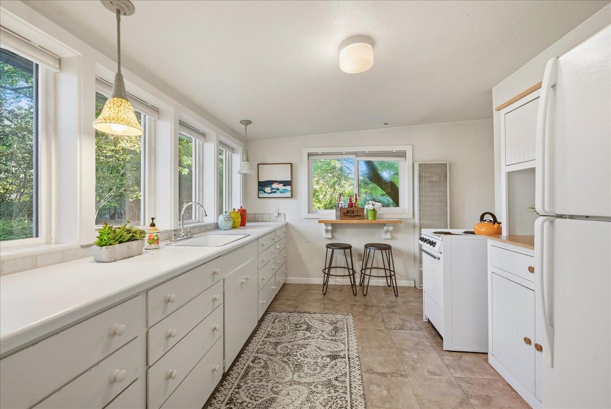 43120 Montgomery Avenue Davis, CA 95618 - Photo 34 of 52 a kitchen that has a lot of furniture in it and wooden floors