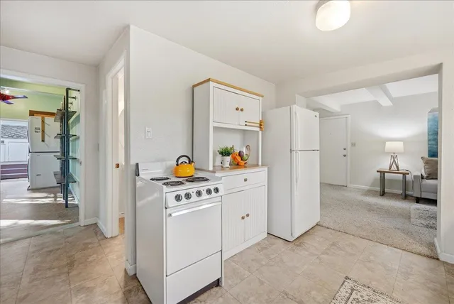 a large bed sitting in a bedroom next to a window