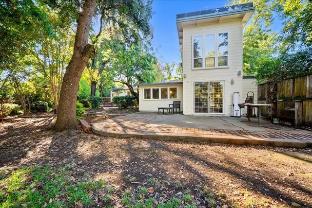 a wooden house with large trees