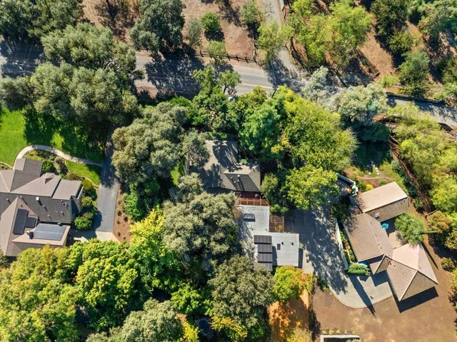 an aerial view of a houses with outdoor space and ocean view