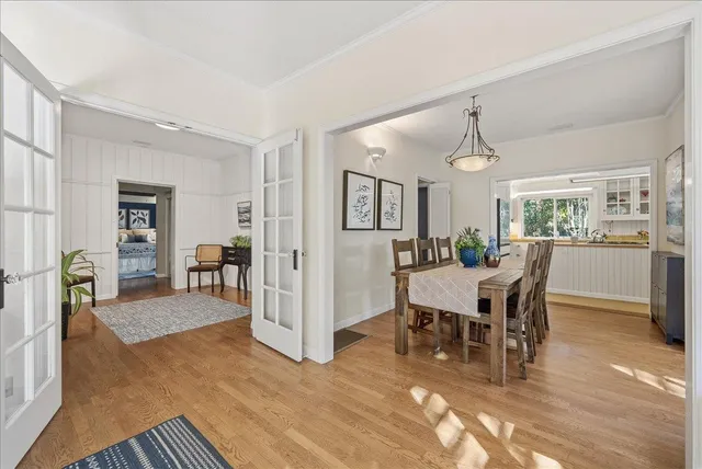 a view of a dining room with furniture and wooden floor