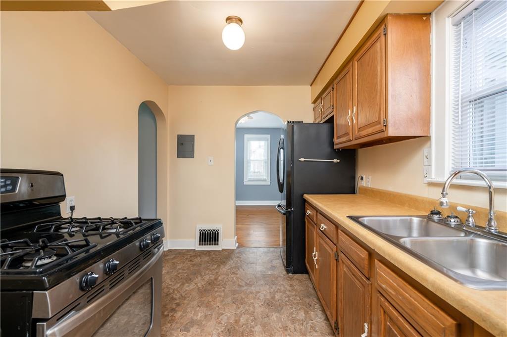 117 Freeport Road Butler, PA 16002 - Photo 11 of 25 a kitchen with granite countertop a stove and a sink