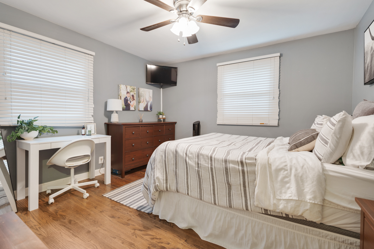 328 South 14th Street St. Charles, IL 60174 - Photo 7 of 20 a bedroom with a bed chair and wooden floor