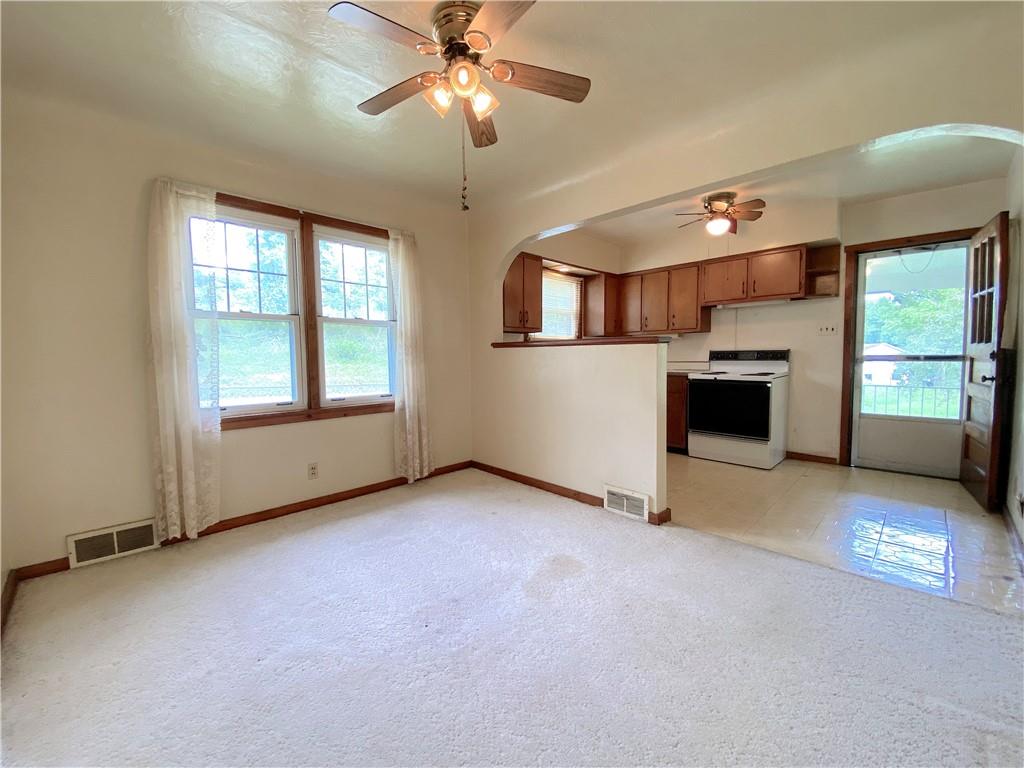 250 Spring Valley Road Jeannette, PA 15644 - Photo 11 of 16 a view of an empty room with a window and fireplace