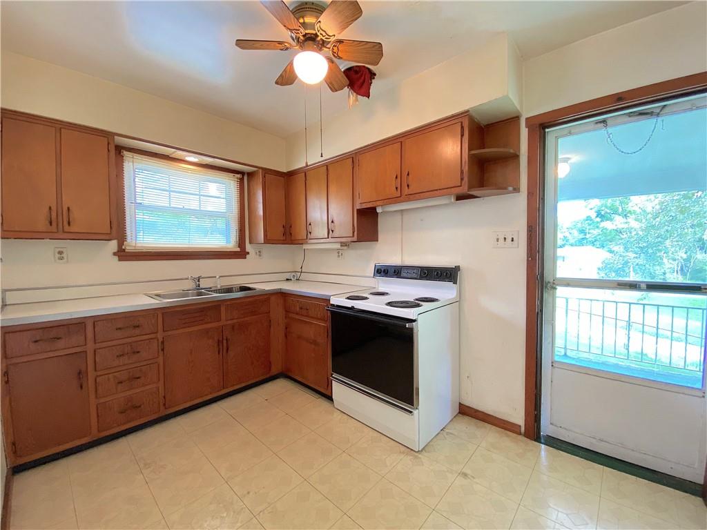 250 Spring Valley Road Jeannette, PA 15644 - Photo 12 of 16 a kitchen with stainless steel appliances granite countertop a stove a sink and a microwave