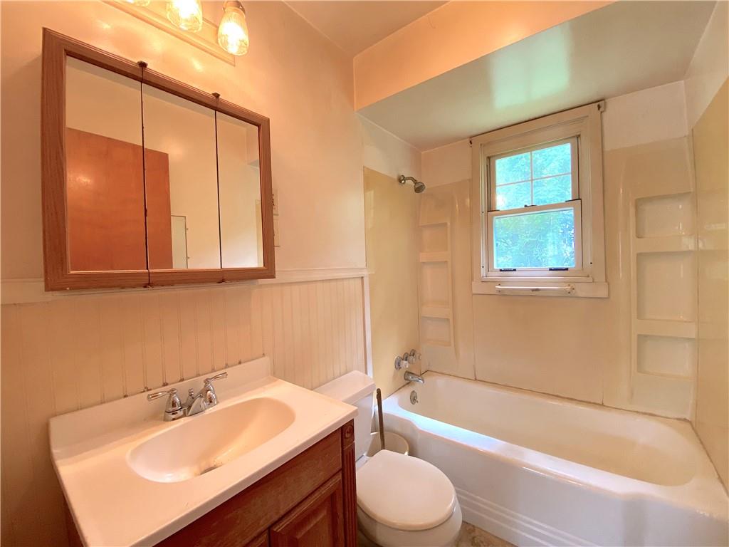 250 Spring Valley Road Jeannette, PA 15644 - Photo 14 of 16 a bathroom with a sink mirror toilet and bathtub
